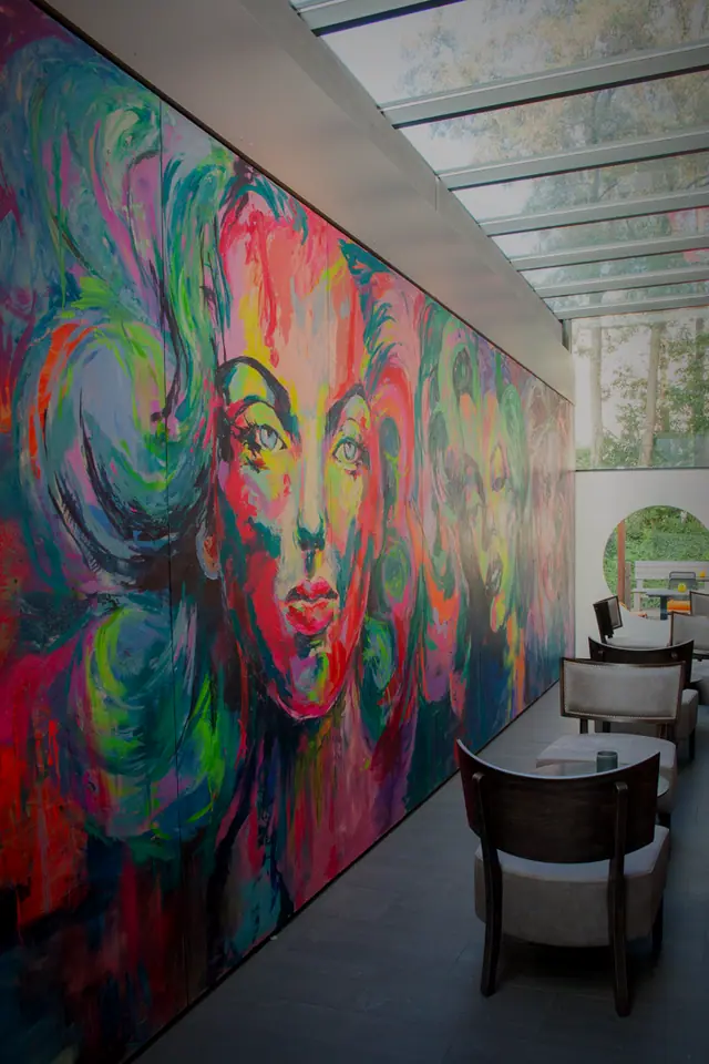 Das hohe Atrium des Angus Club mit großem Wandbild